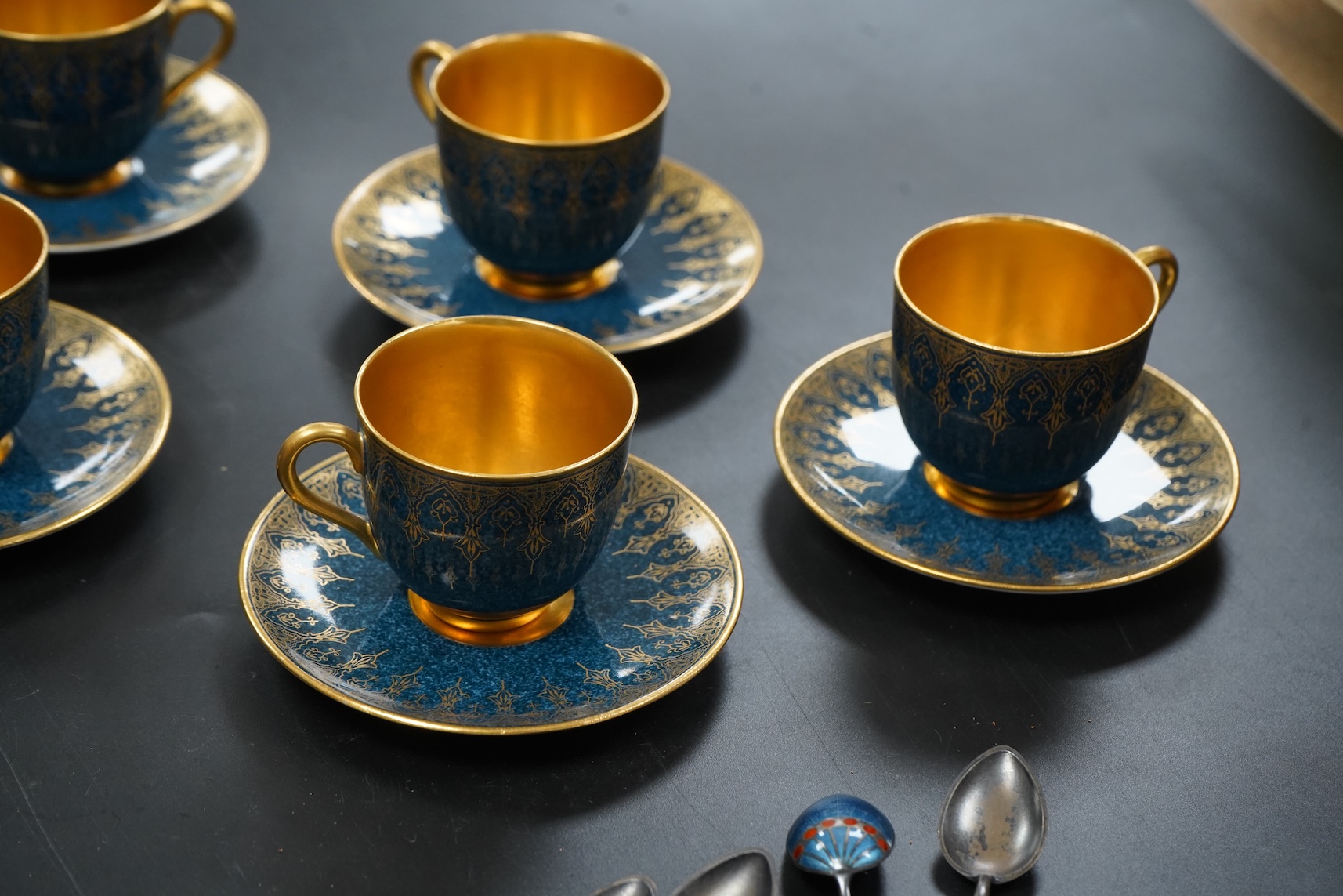 A set of six Royal Worcester cups and saucers, powder blue and gilt decoration, together with a set of six silver and enamel teaspoons